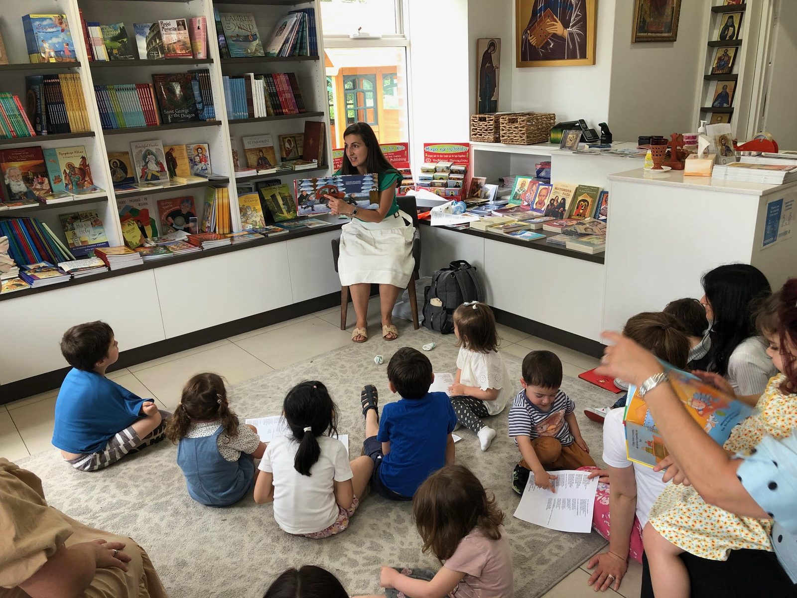 Children and parents gathered for a Storytime reading session inside the Orthodox Mission Bookstore